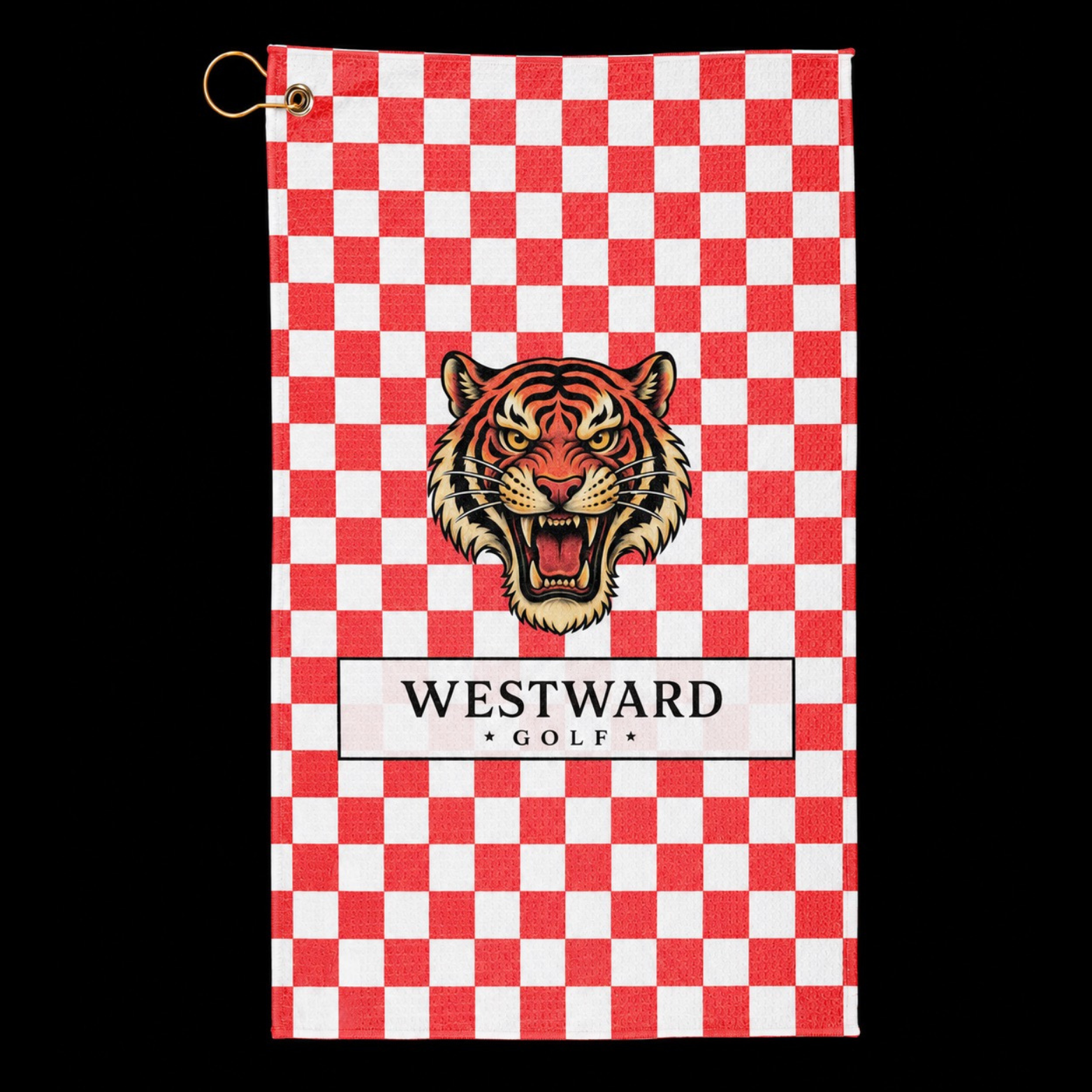 Red and white checkered Westward Golf towel with bold vintage roaring tiger logo, premium checkerboard golf towel on black background with gold hanging ring and brass grommet, stylish golf bag accessory for cleaning golf clubs, golf balls, grips, hands, and gear during every round.