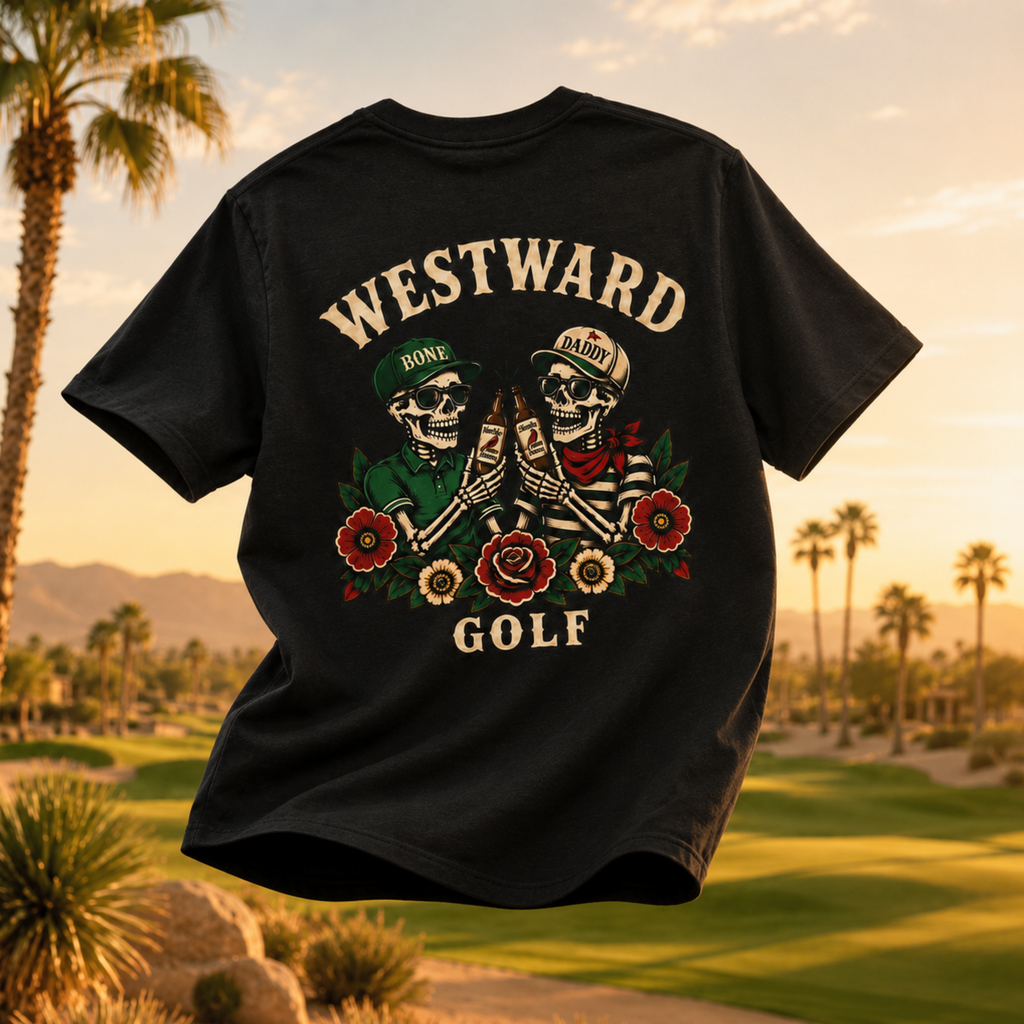 Black Westward Golf skeleton graphic t-shirt floating over sunset golf course with vintage beer toast artwork, floral back print, palm trees, and desert mountain background